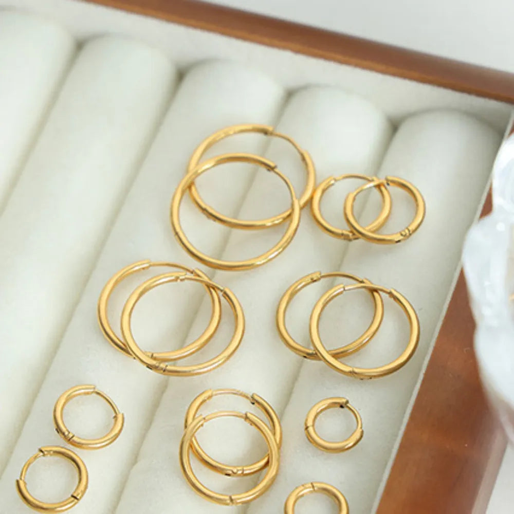 Minimalist gold vermeil huggie hoop earrings in various sizes.