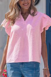Pink and white striped textured short sleeve blouse with flutter sleeves and V-neck.