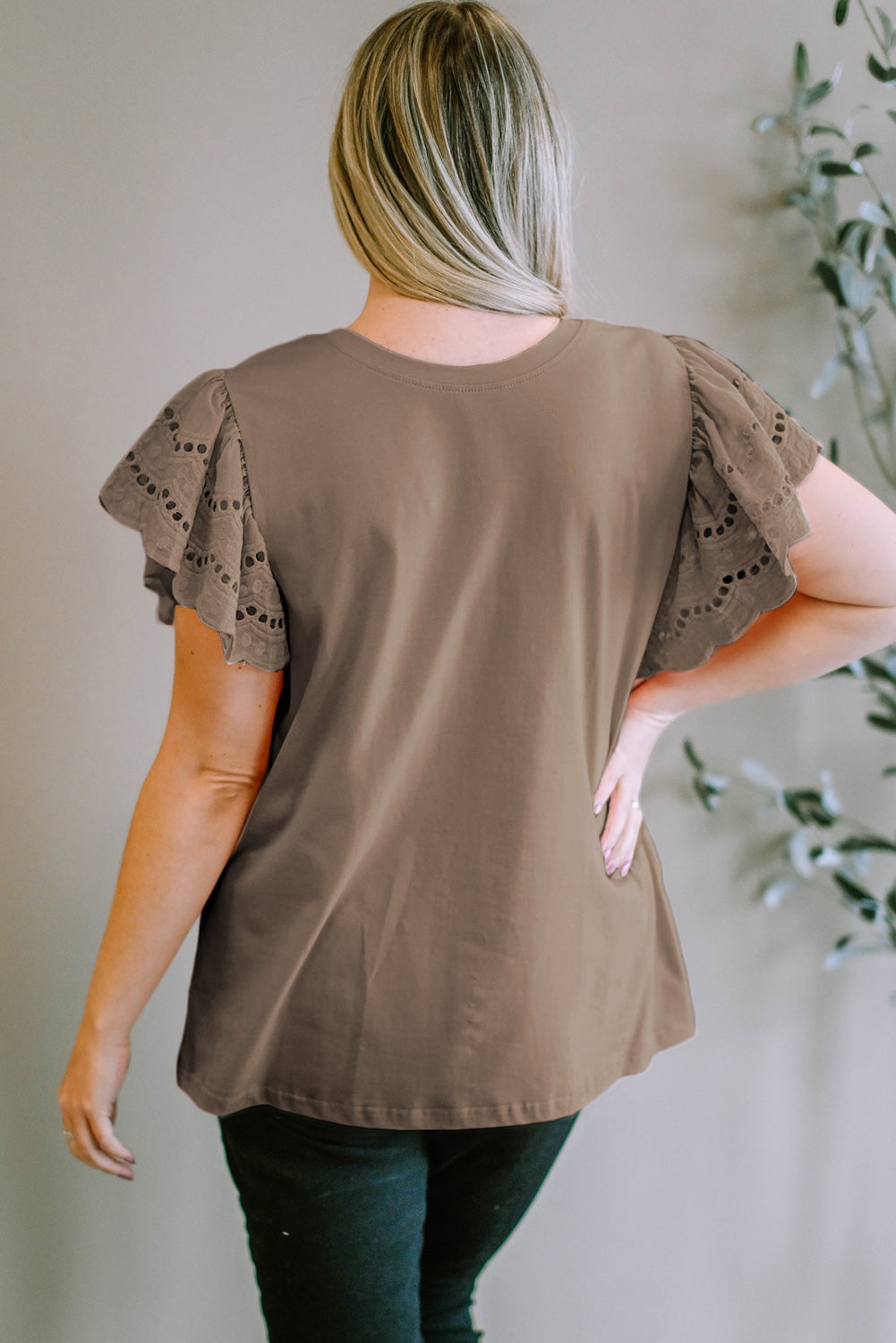 Mocha eyelet flutter sleeve tee with a round neckline.