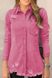 Pink distressed denim shirt jacket with raw edges and button front.