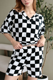 Black and white checkered v-neck tee and shorts outfit set.