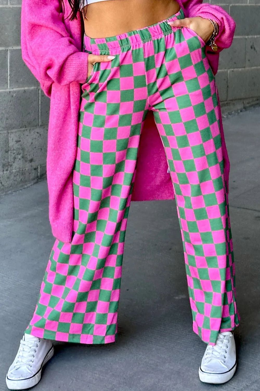 Checkerboard palazzo trousers in fuchsia pink and green with a wide leg and elastic waist.