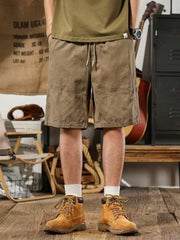 Men's taupe drawstring shorts, relaxed fit, casual style with detailed stitching.