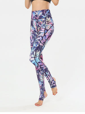 Prism Palm stirrup leggings in multi-color leaf print with black trim.