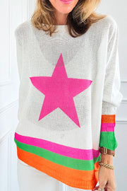 White knit sweater with neon pink star and striped hem.