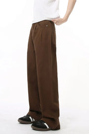 Chocolate wide-leg denim trousers with front pleats and a relaxed fit.