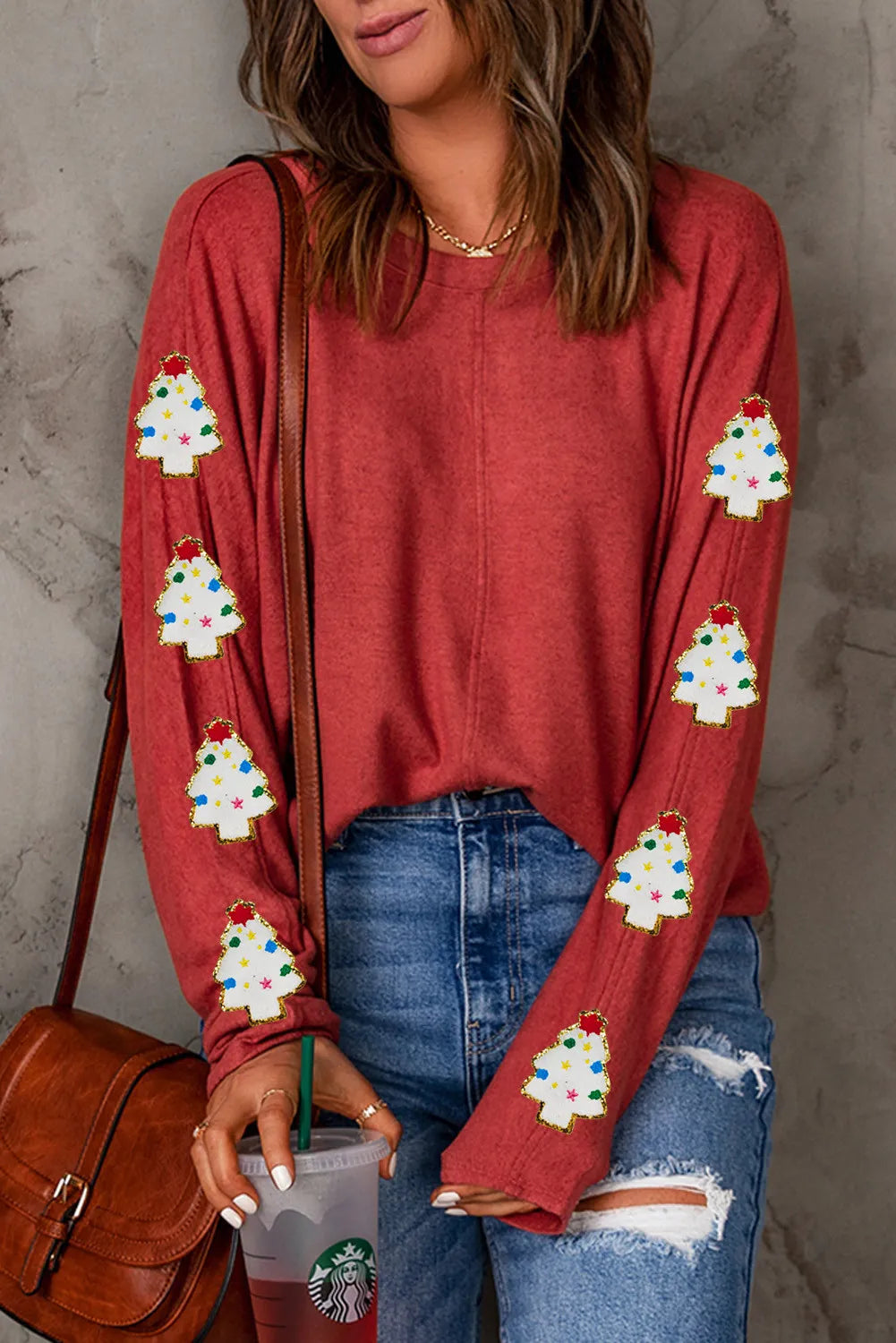 Scarlet long sleeve sweater with embellished Christmas tree patches on sleeves.
