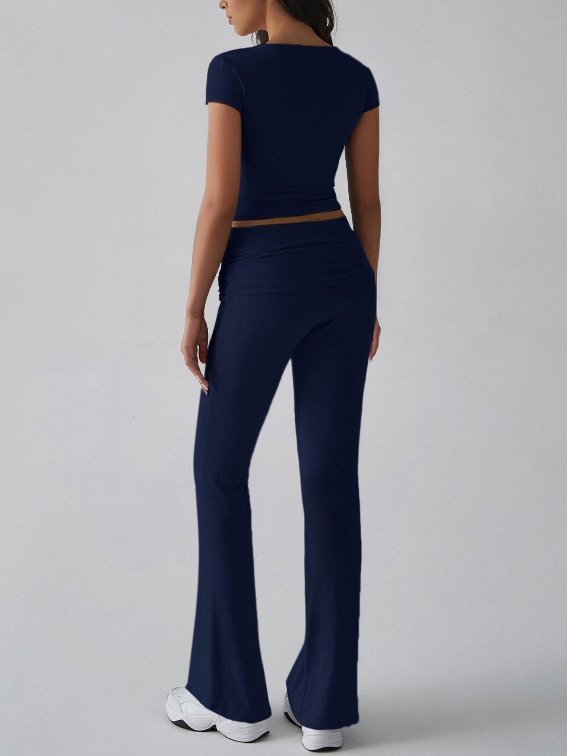 Dark blue ribbed flare leg lounge set with short sleeve crop top and high waist pants.