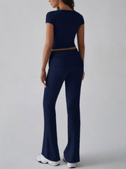 Dark blue ribbed flare leg lounge set with short sleeve crop top and high waist pants.