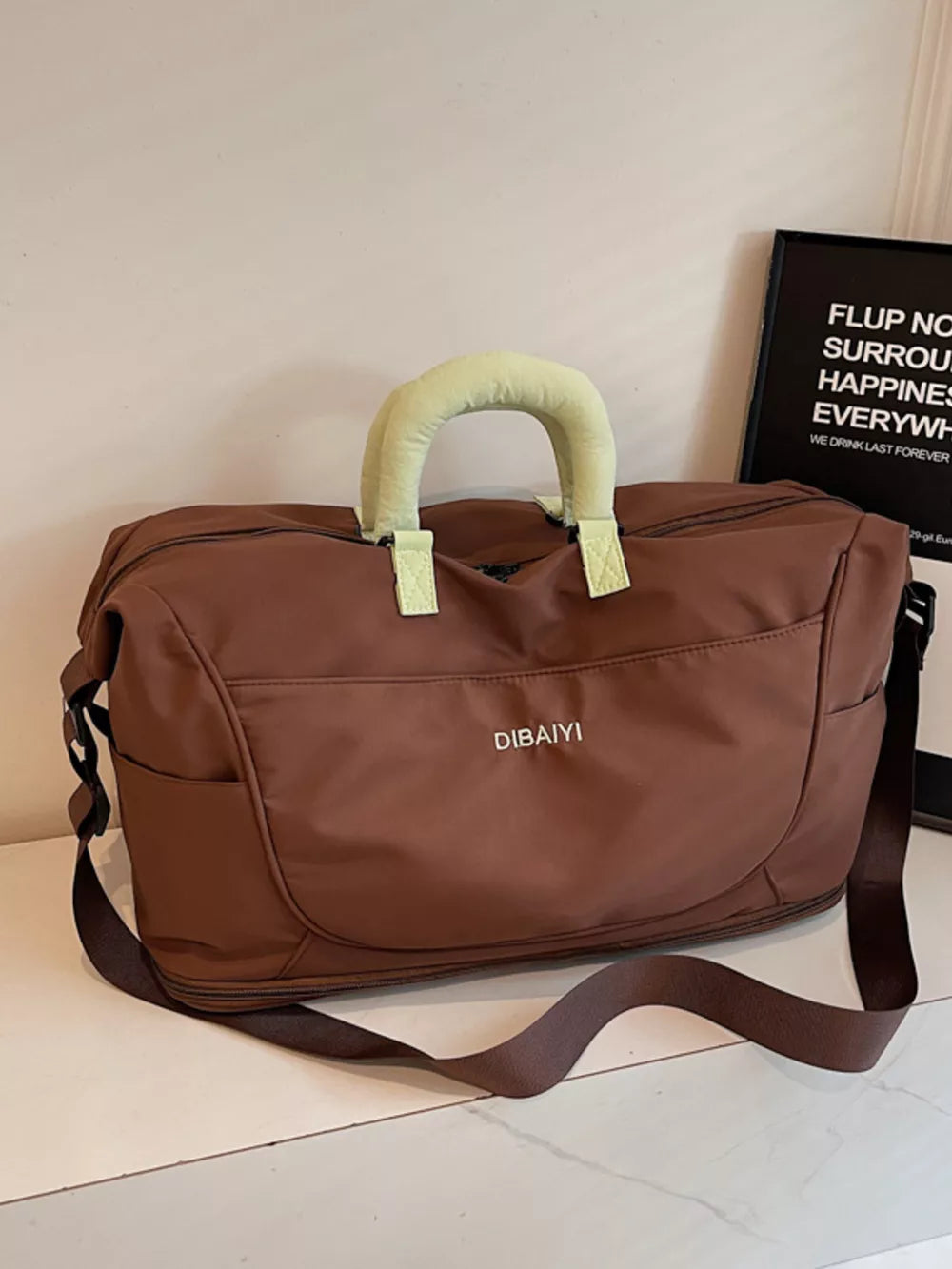 Brown Oxford cloth duffel bag with padded handles and shoulder strap