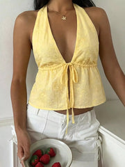 Yellow embroidered polyester halter tank top with a plunging neckline and tie front.