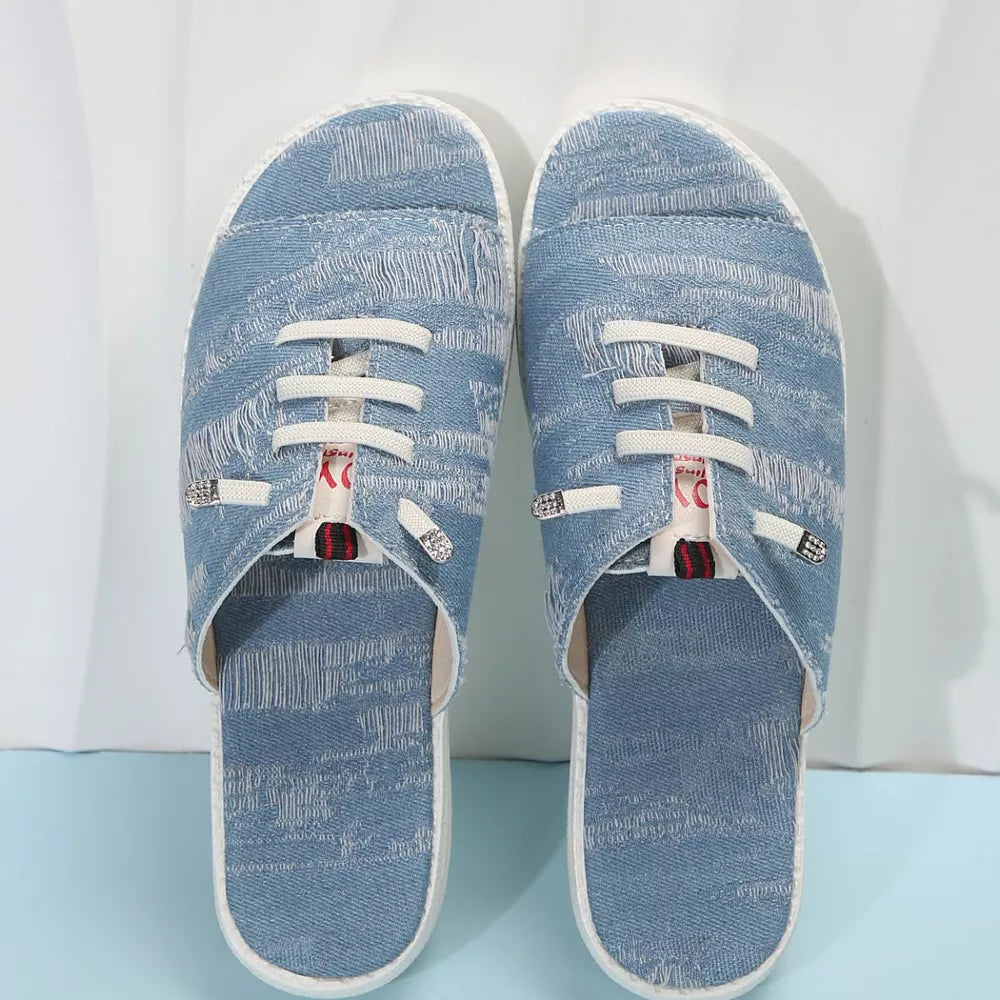Light blue distressed canvas open-toe platform sandals with white laces and decorative details.