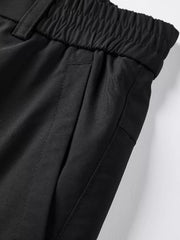 Black cargo pants with elastic waistband and side pockets.