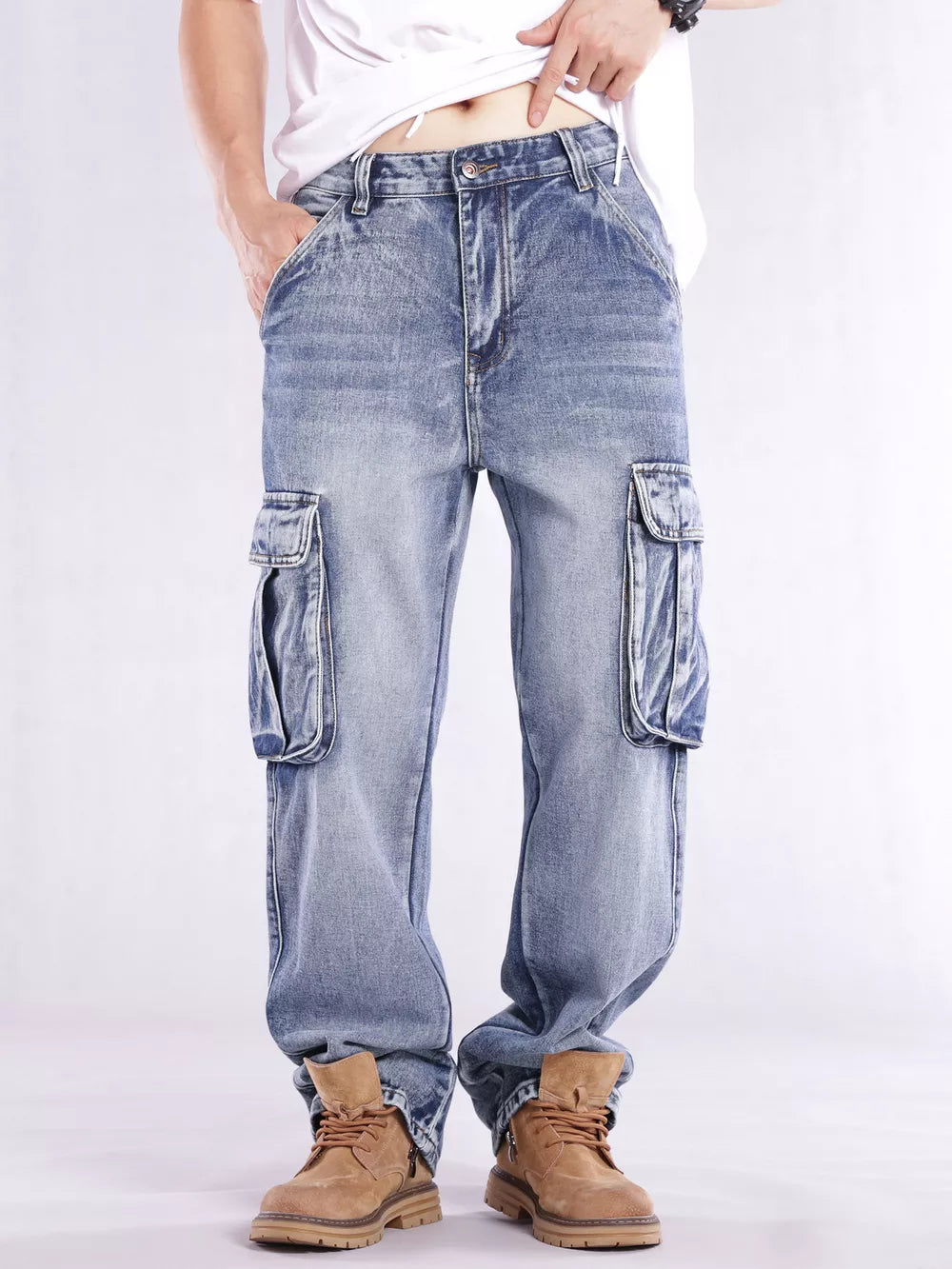 Relaxed fit light wash denim cargo jeans with flap pockets and contrast stitching.