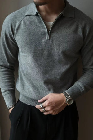 Raglan sleeve zip-through knit polo in dark gray with a ribbed collar and cuffs.