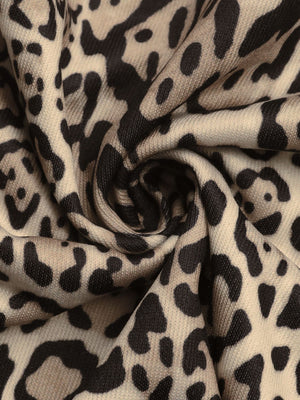 Leopard print jacket fabric detail in tan and black.
