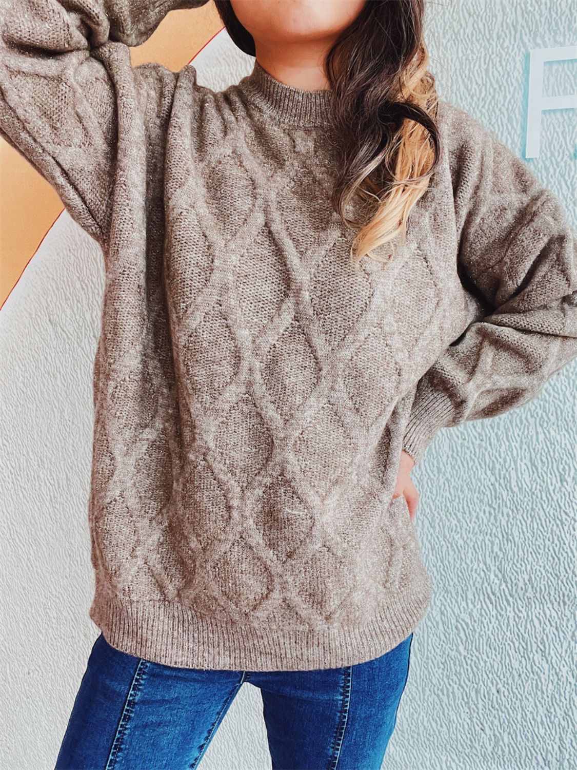 Beige knit sweater with diamond pattern, crew neck, and relaxed fit.