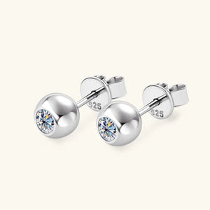Silver bezel-set crystal stud earrings with a bright, round cut stone.