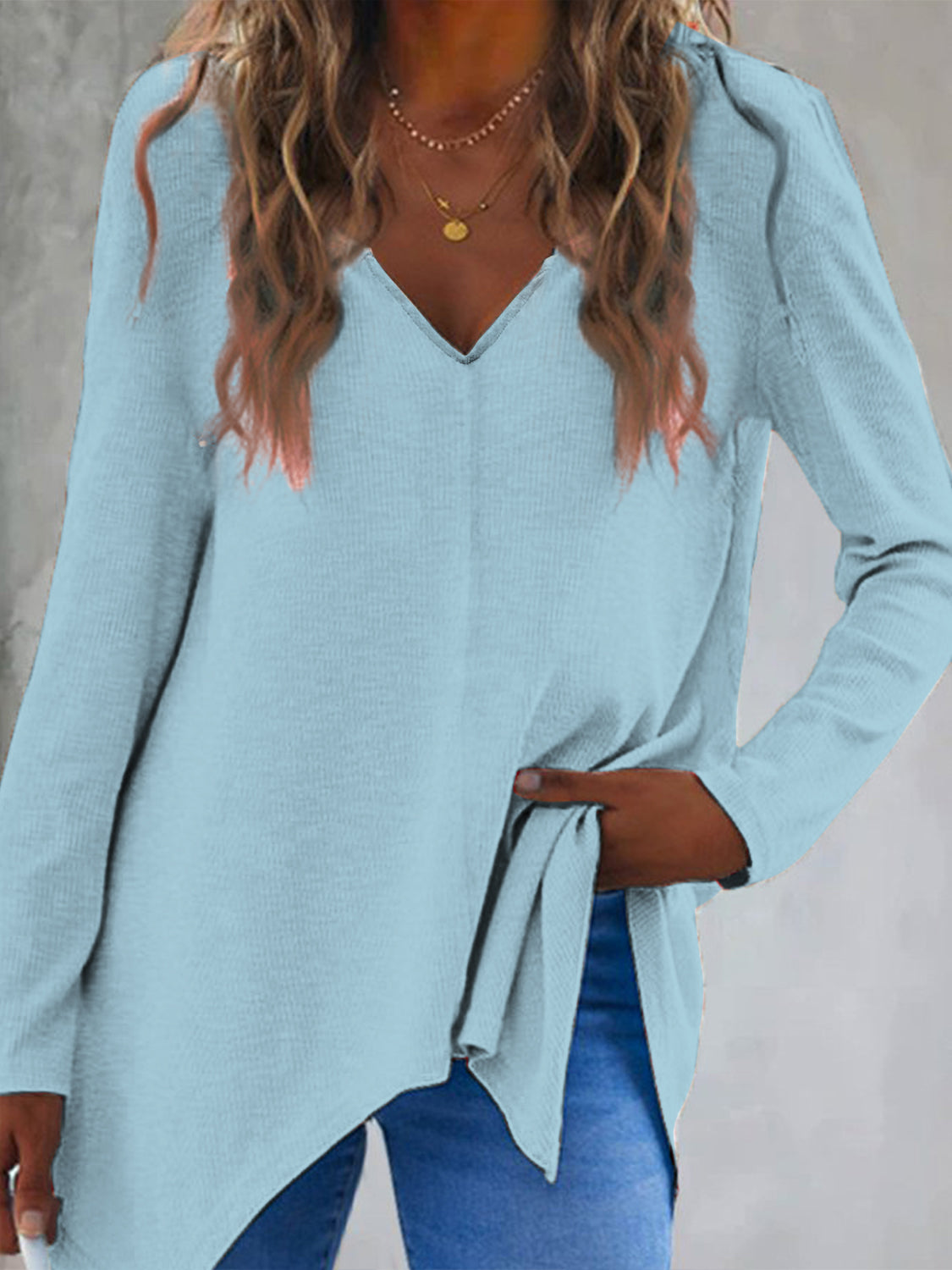 Pastel blue ribbed knit tunic with V-neck and asymmetric hem