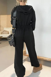 Black hooded lounge jumpsuit with drawstring waist and wide legs.