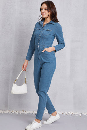 Denim utility jumpsuit in medium wash with defined waist, button front, chest pockets, and straight leg.