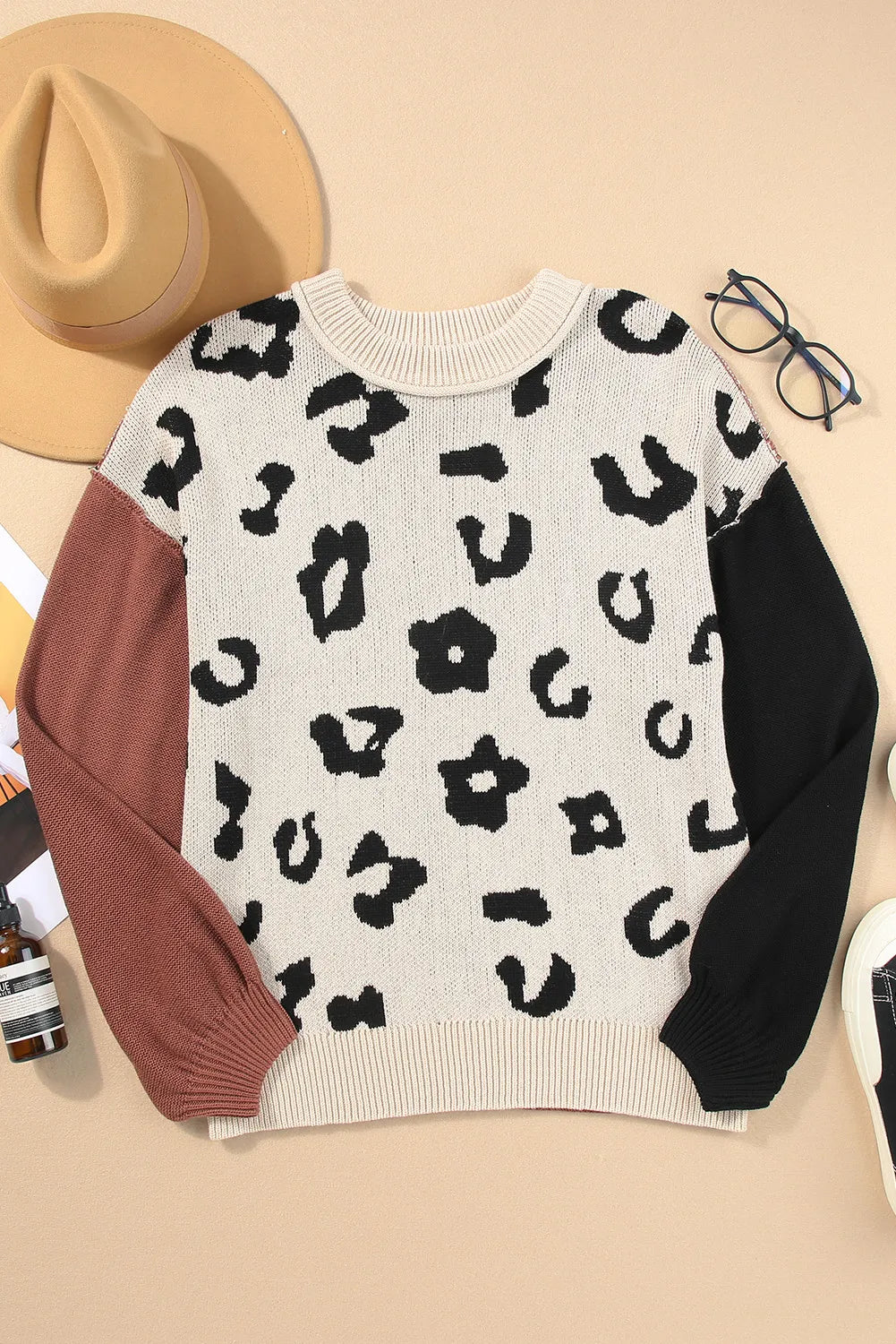 Colorblock leopard print knit sweater with crew neck and long sleeves in acrylic and cotton blend.