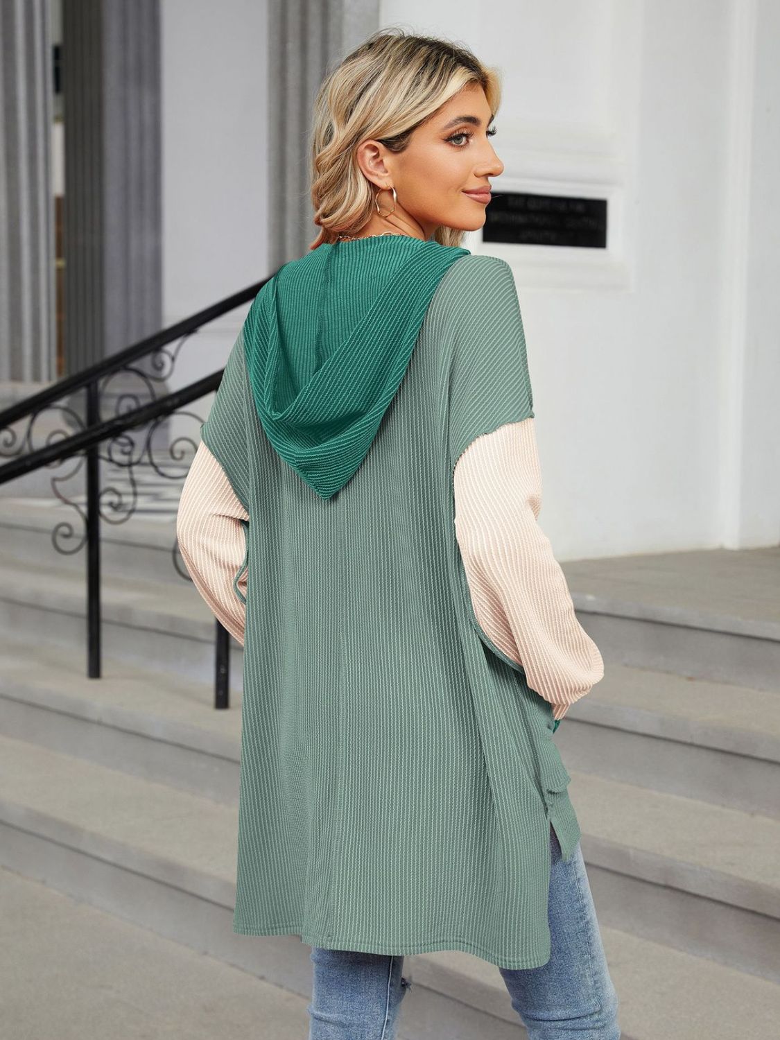 Waffle knit colorblock hooded tunic with contrast sleeves and side slits.