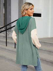 Waffle knit colorblock hooded tunic with contrast sleeves and side slits.