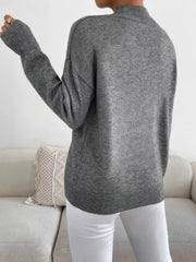 Gray mock neck sweater with dropped shoulders and ribbed cuffs and hem.