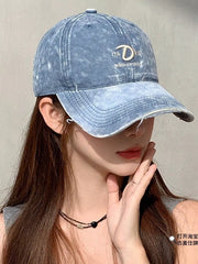 Blue denim baseball cap with distressed details and embroidered logo