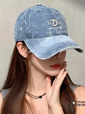 Blue denim baseball cap with distressed details and embroidered logo