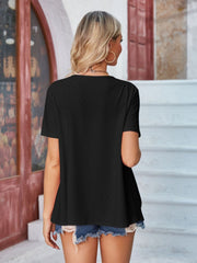 Black perforated short sleeve jacket with a shawl collar.