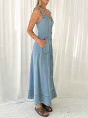 Light wash denim A-line midi dress with button front, square neckline, and patch pockets.