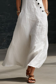 White asymmetrical button-down midi dress with pockets and a flowing A-line skirt.