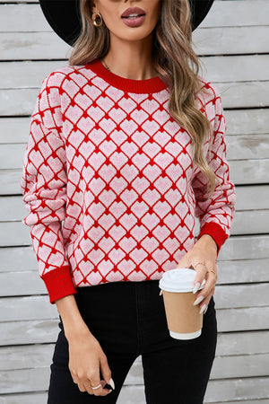 Heart grid crewneck knit sweater in pink and red acrylic with a diamond pattern.