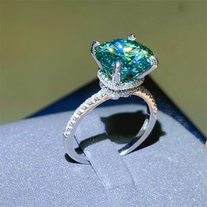 Radiant teal moissanite pavé ring in silver with a large center stone.
