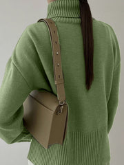 Matcha green ribbed turtleneck sweater with flared sleeves and a crossbody bag.