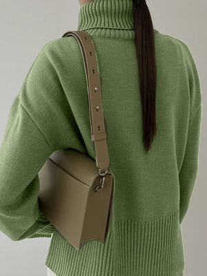 Matcha green ribbed turtleneck sweater with flared sleeves and a crossbody bag.