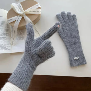 Gray ribbed knit touchscreen gloves with a pink detail on the index finger.
