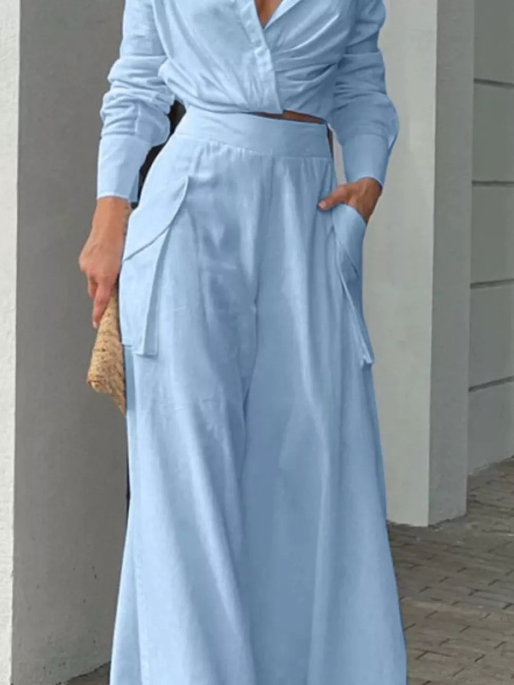 Light blue polyester two-piece set with pocketed wide-leg pants and a long-sleeve crop top.