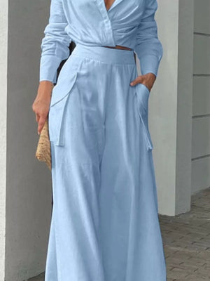 Light blue polyester two-piece set with pocketed wide-leg pants and a long-sleeve crop top.