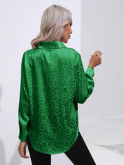 Green satin leopard print blouse with a collared neckline and long sleeves.