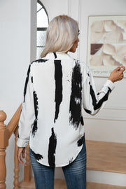 White and black brushstroke print silk-blend button-down blouse with a relaxed fit.