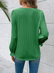 Mid Green textured blouse with pleated sleeves and ruffled cuffs.