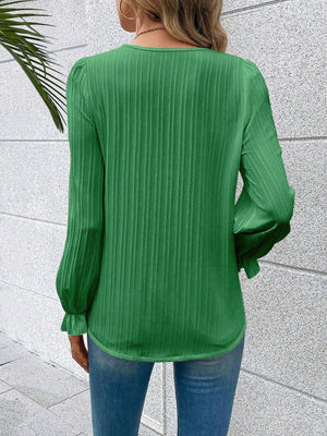 Mid Green textured blouse with pleated sleeves and ruffled cuffs.
