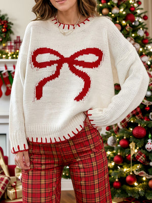 Ivory knit sweater with red bow graphic and contrast stitching, crew neck, long sleeves.