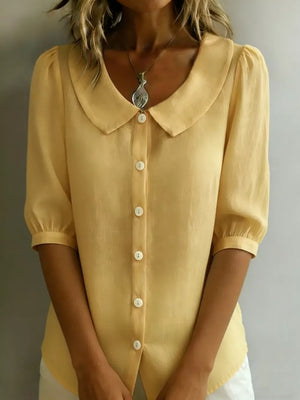 Pastel yellow button-down shirt with puff sleeves and Peter Pan collar