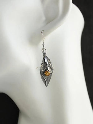 Textured leaf citrine drop earrings with yellow stone and silver tone metal.