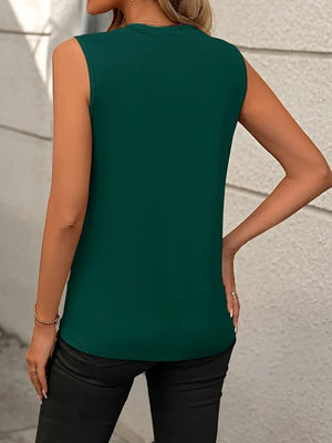 Sleeveless dark green tank top with diagonal seam detail, crew neck, and a relaxed fit.