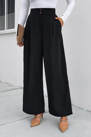 Black high-rise ruched wide-leg trousers with button detail and pockets.